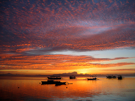 Boats and sky on fire
