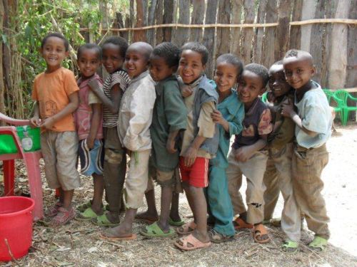 boys line up to wash their hands