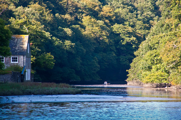 A canoe disappearing into the distance on the River Lerryn