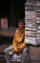 Used newspaper seller on an Indian market