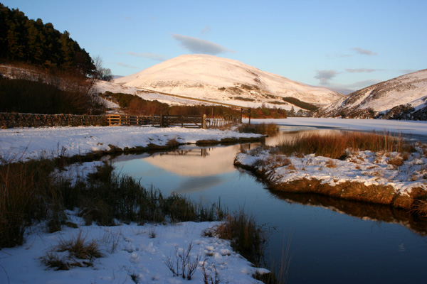 Logan Burn and a snowy Castlelaw Hill
