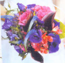 Bridesmaid's hand-tied bouquet in pretty shades of pinks and purple.