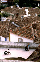 Children play on a rooftop in Obidos, Portugal. 2007