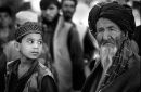 Panjshir Valley, Afghanistan, 1999.  A boy watches his grandfather after having fled advance by Taliban Forces.