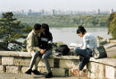 Students kiss in a park overlooking the River Sava in Belgrade, Serbia. 2001.