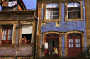 People look from their homes on a summer evening in Oporto, Portugal. 2002.