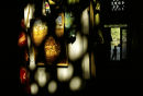 Sunlight illuminates the interior of a souvenir shop in Bukhara, Uzbekistan. 1999.
