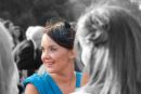 A photograph of a wedding guest with the background converted to monochrome