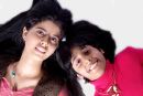 Photograph of two sisters on a white backdrop