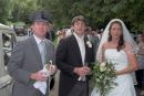 Bride and groom photographed as the cork flies off