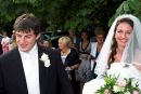 the bride and groom leave the church