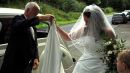 Photograph of the bride and her father arriving at the church